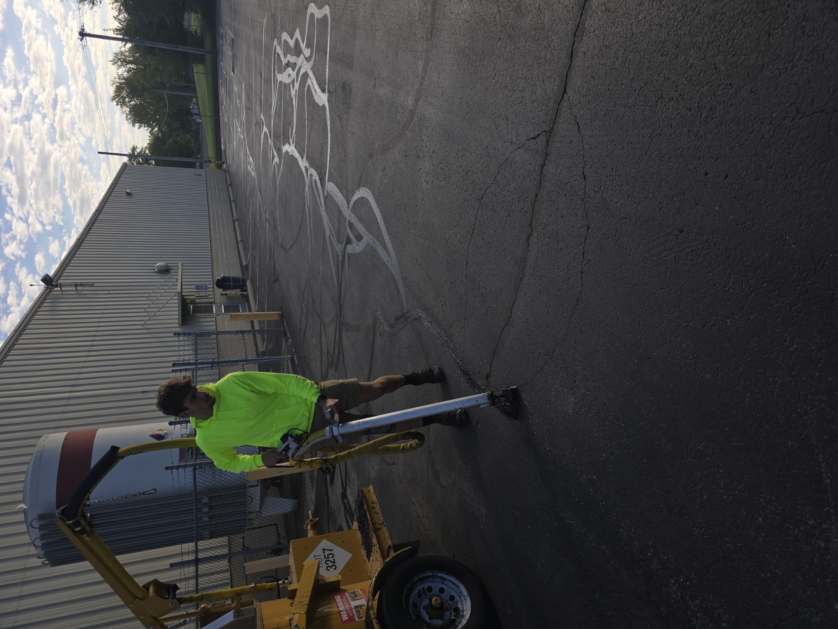 Crack sealing in progress on a commercial lot