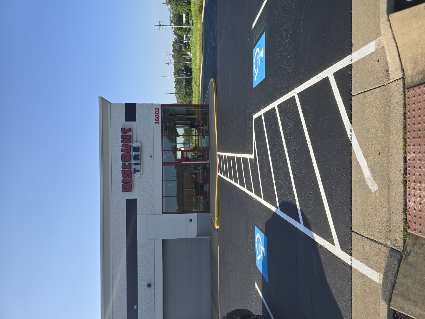 Fresh ADA striping at a commercial storefront