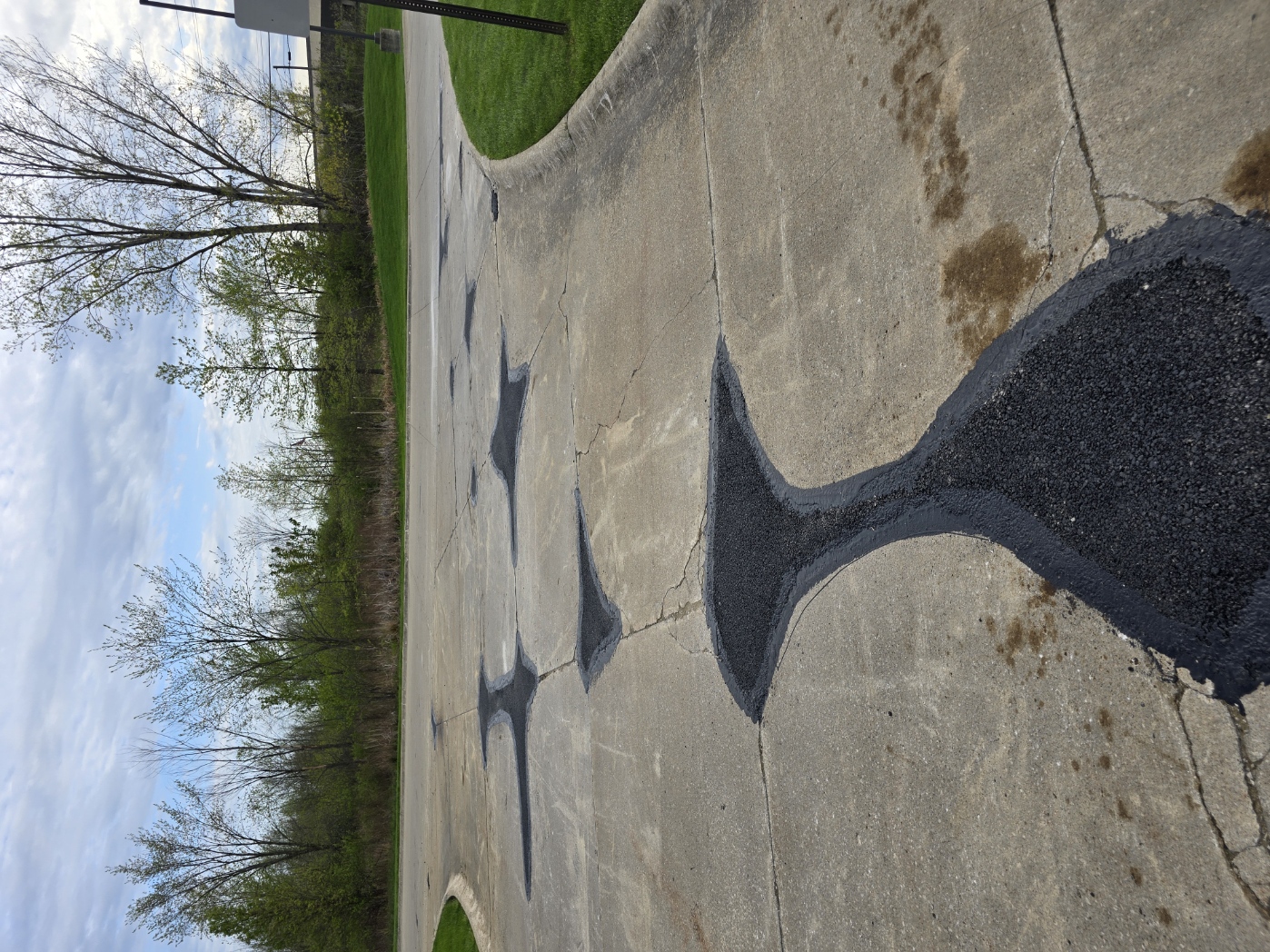 Large asphalt patch repair at a hotel parking area